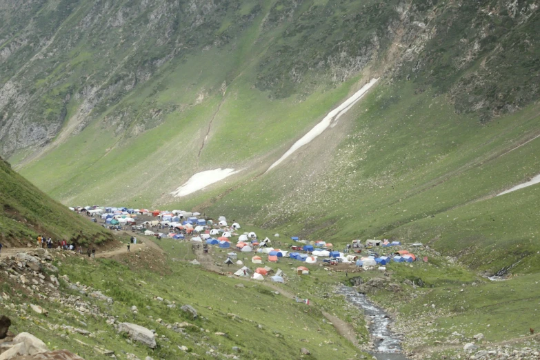 people camping out on the side of a mountain