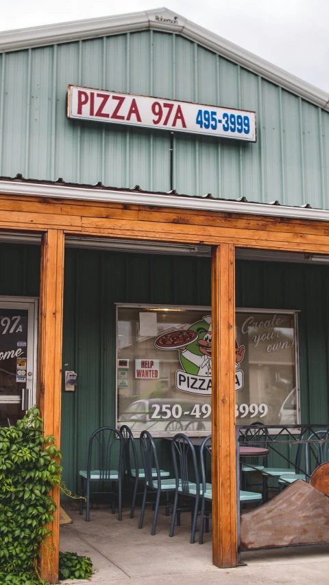 a large restaurant with pizza signs above the doors