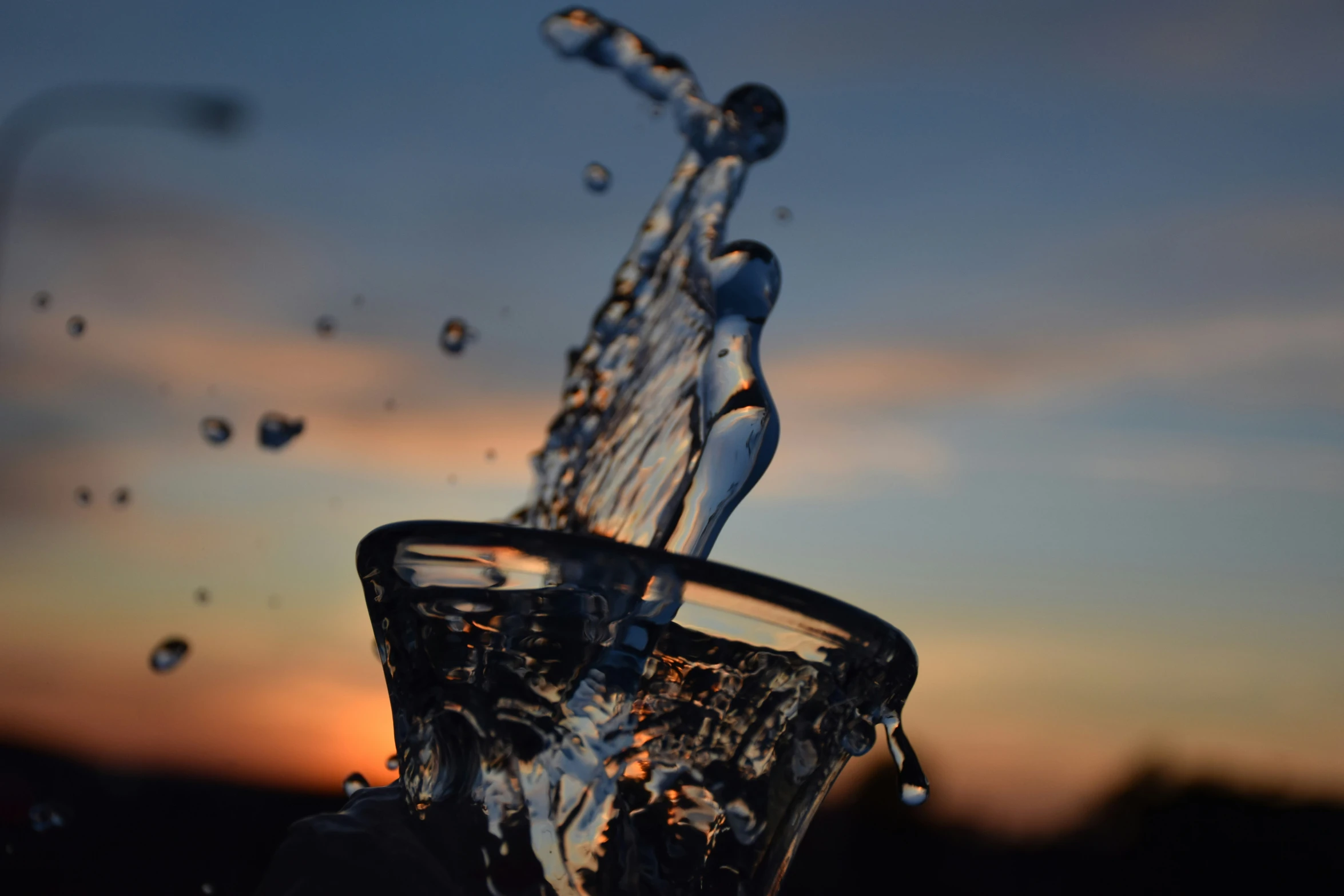 there is water that is falling into the glass