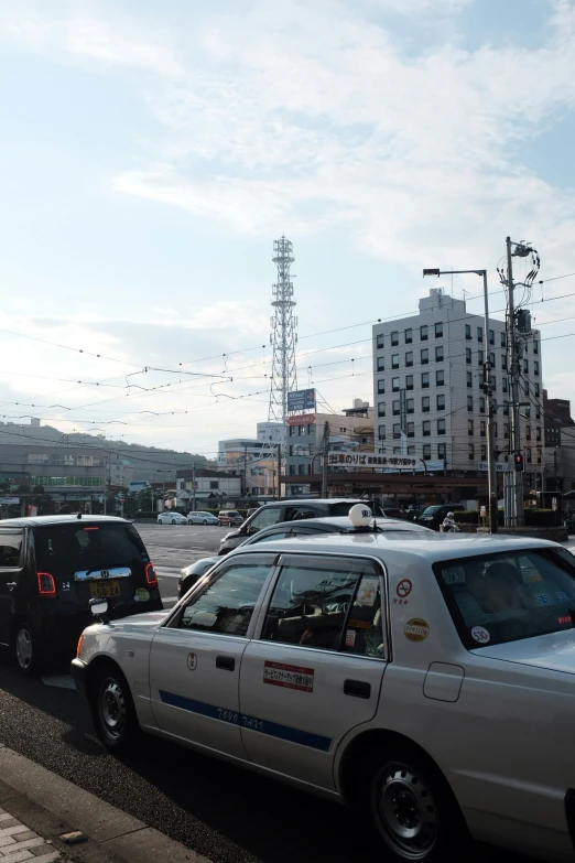 vehicles driving down the road in traffic in a city