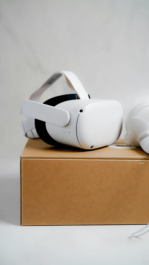 a white pair of shoes with a protective cover sitting on top of a cardboard box