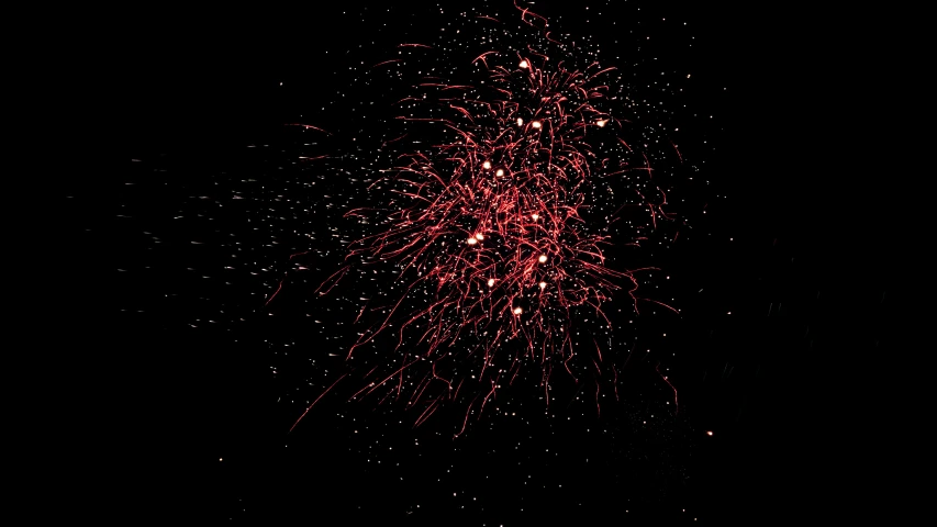 red fireworks in the sky with sparkle coming out