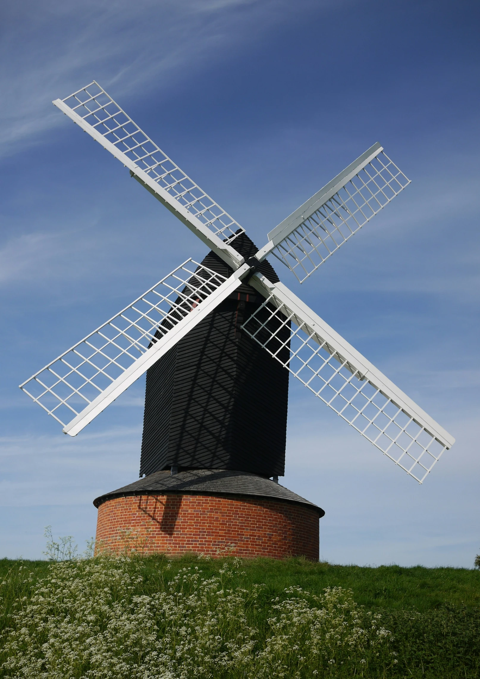 the windmill is standing out on a hill