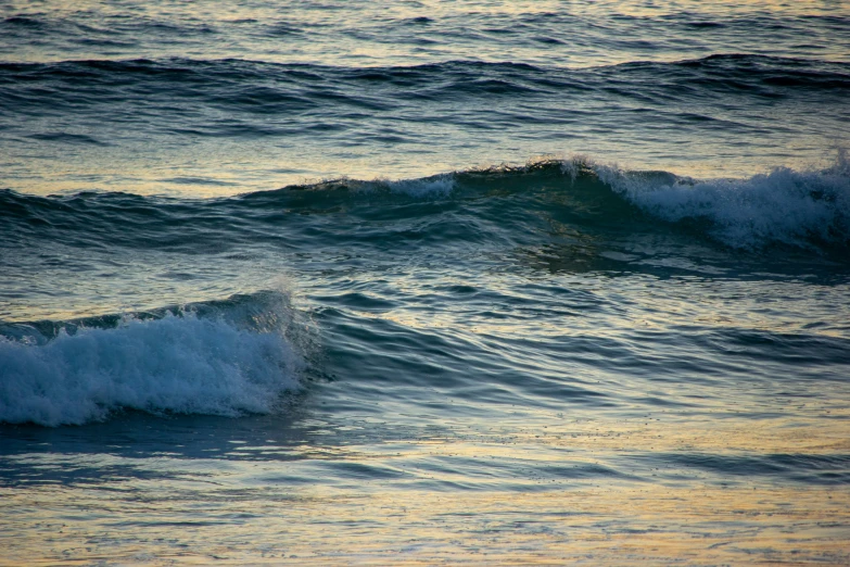 an ocean wave rolls in over the top of a bright orange background