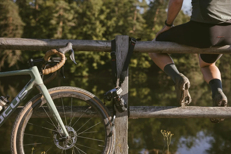 a person riding on a wooden bike over a railing