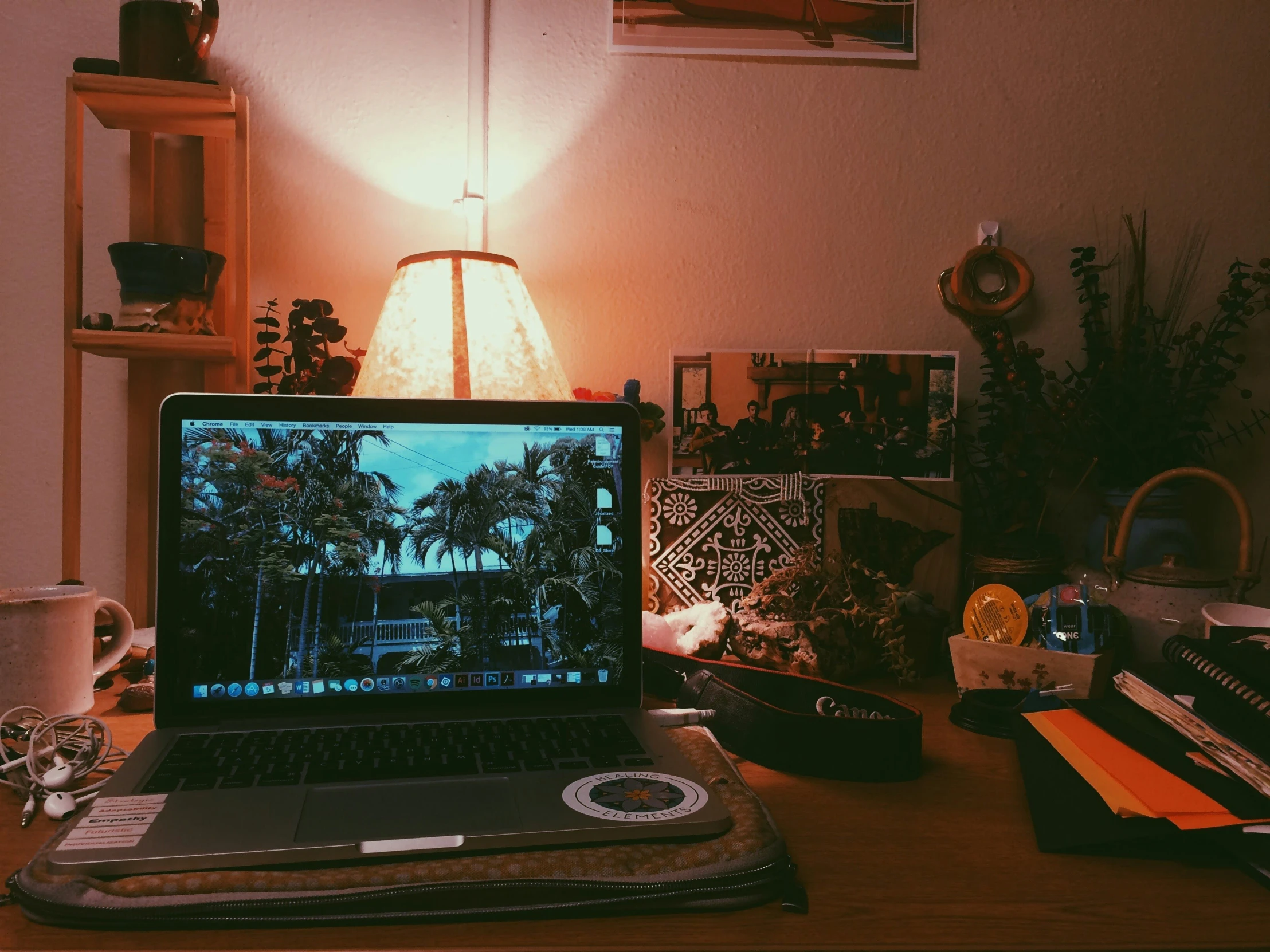 a laptop on a desk in a room with pictures and decor