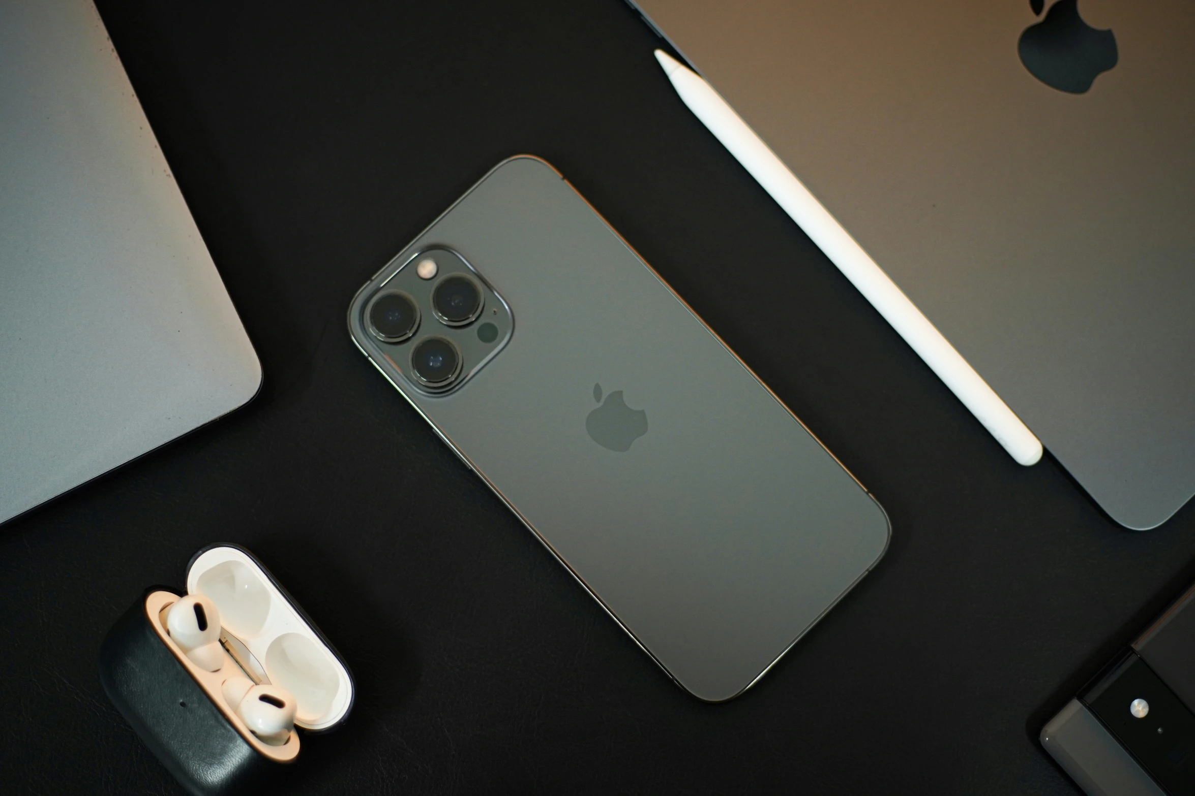 an apple smartphone and some iphone accessories are on the table