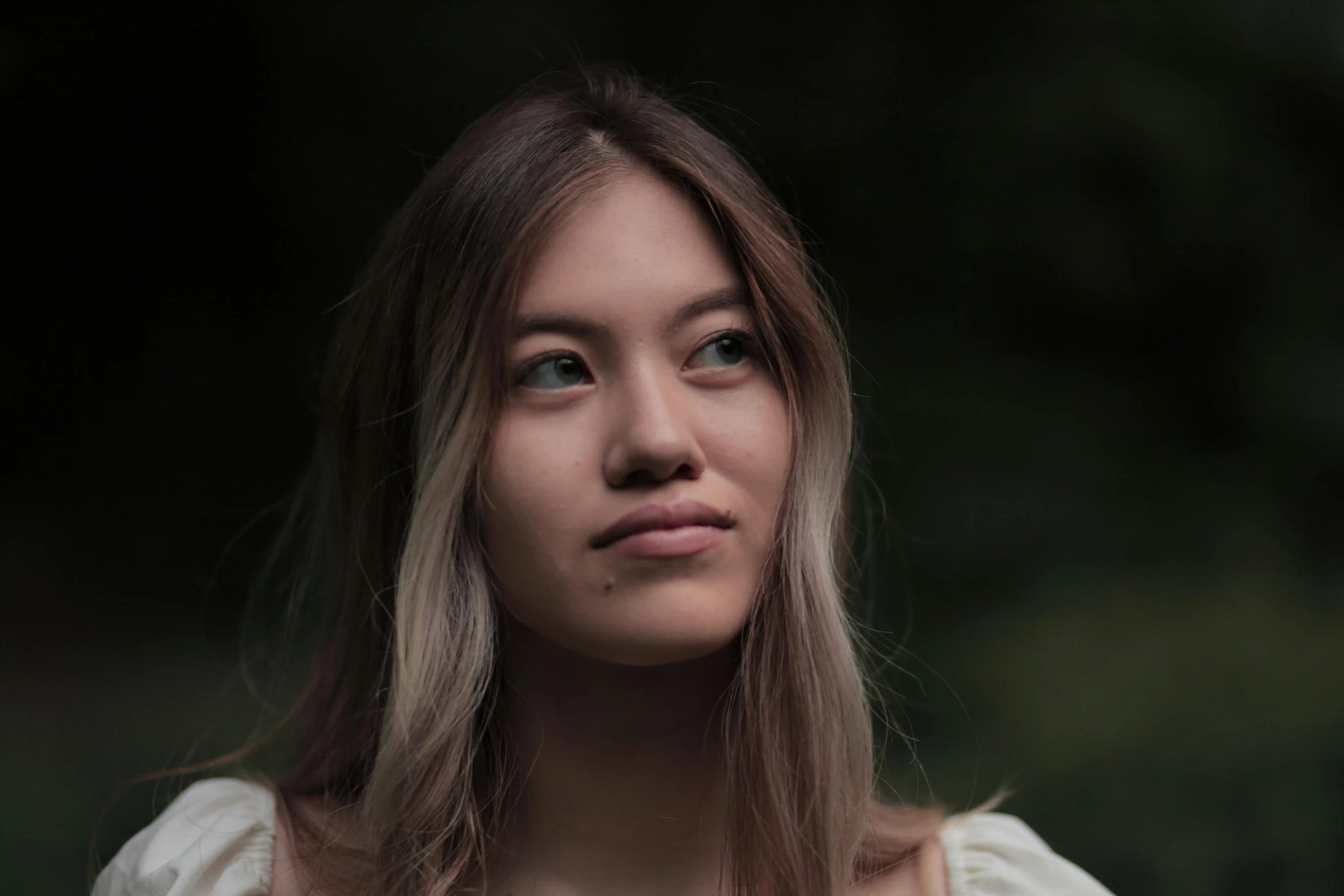 a girl with long brown hair looking at the camera