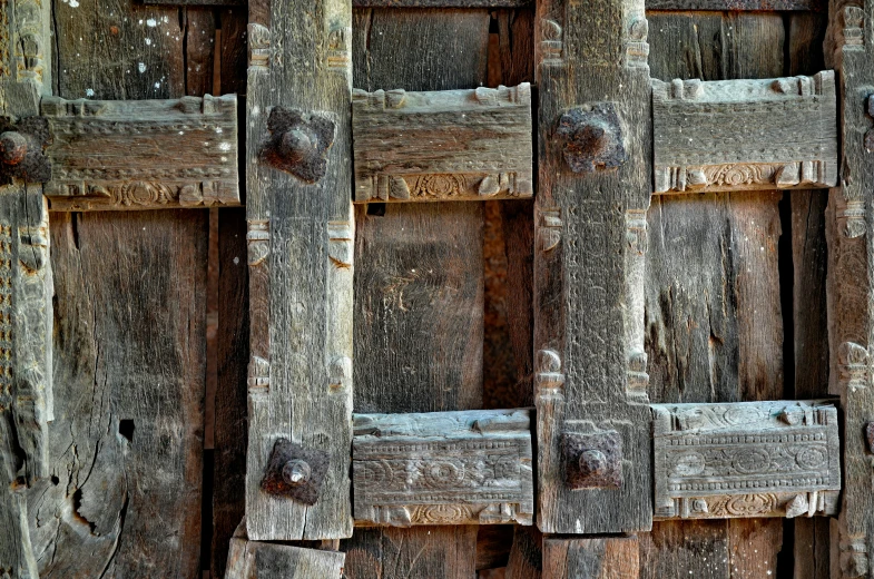 several wooden boards and nails of a wall