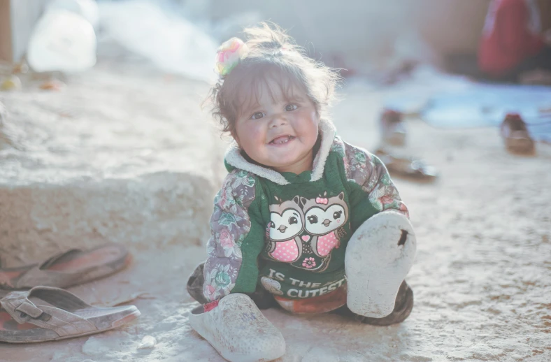 a small child holds a stuffed animal in her hands