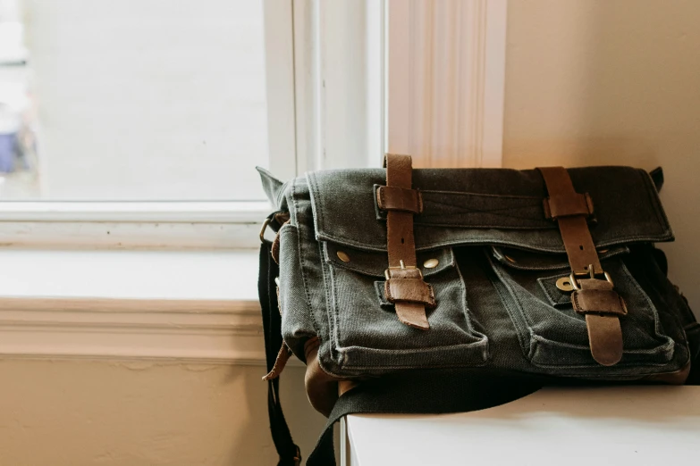 there is a bag with straps sitting on the window sill