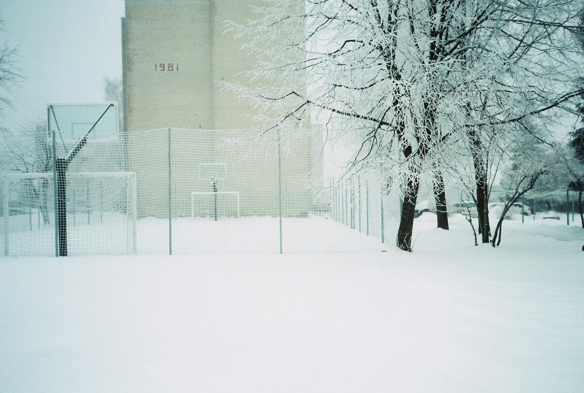 the building is located behind a large fence in the winter