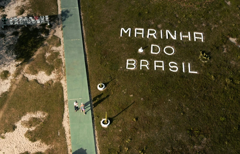 two children are walking next to the writing martina do sil