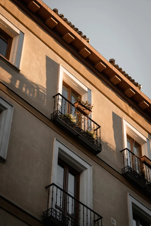 a tall beige building with balconies and balconyes