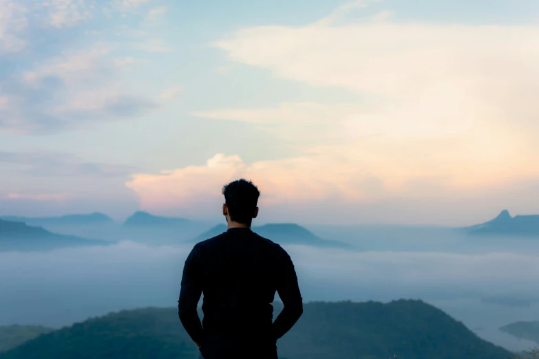 a person in the foreground with an image of mountains