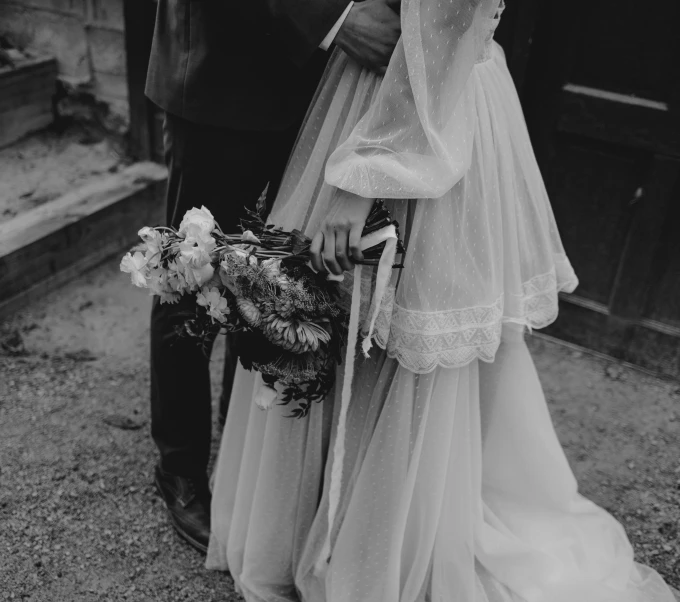 a man and woman dressed in fancy clothing holding hands