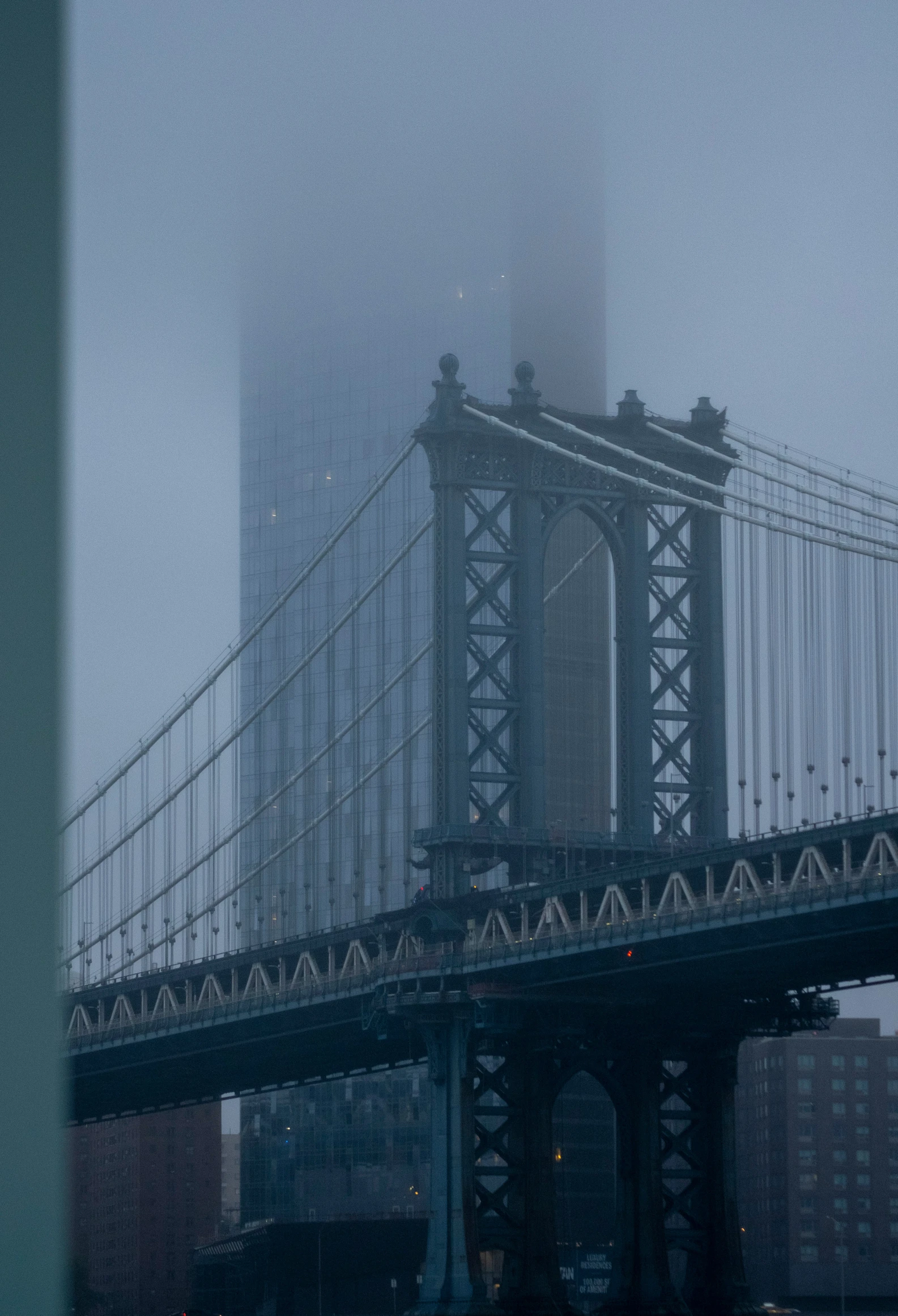 a bridge that is over some water and fog