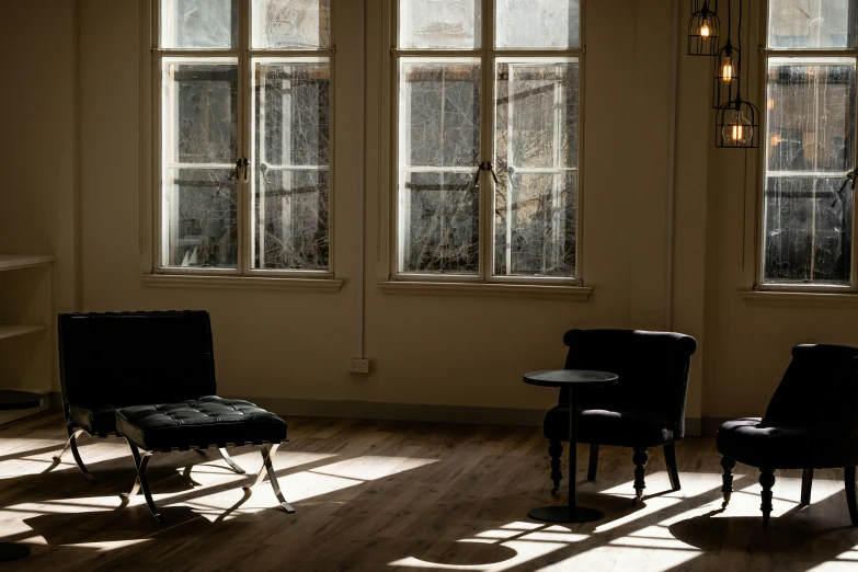 a set of three chairs are sitting in the corner of an empty room