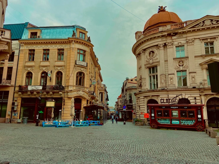 an old city street is dotted with tall buildings and cobblestones