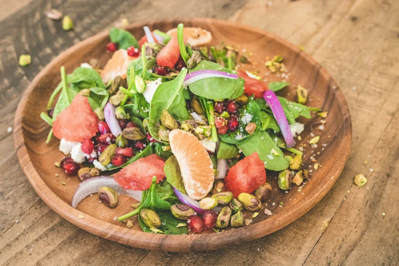 this salad contains various veggies in a wooden bowl