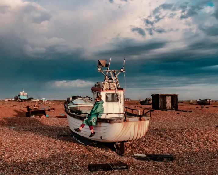 a small boat in the dirt with a sky background