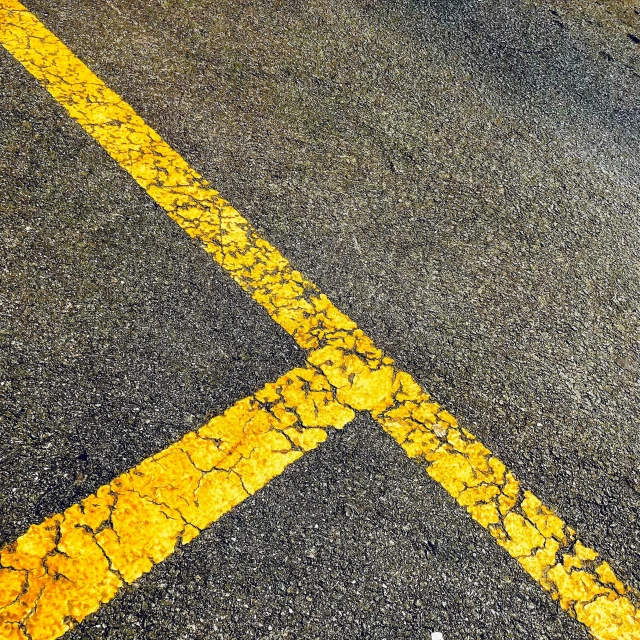 a cross is shown on the street by itself