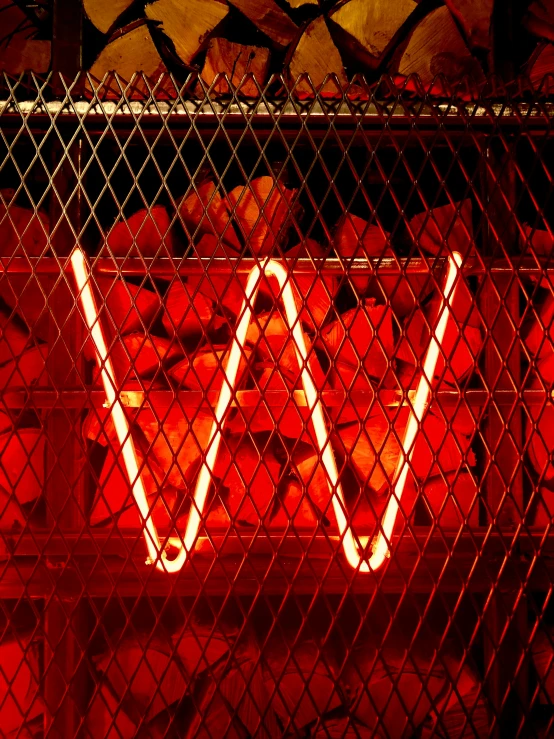 a large metal wire cage with orange lights inside of it