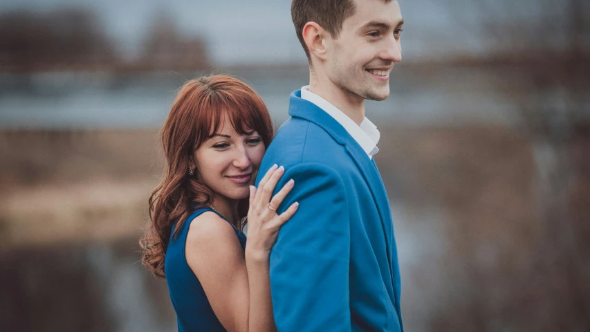 a close up po of a young woman emcing a man