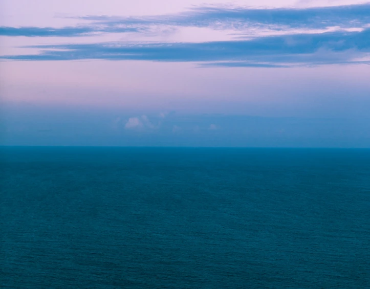 there is a large body of water that has a boat out on it