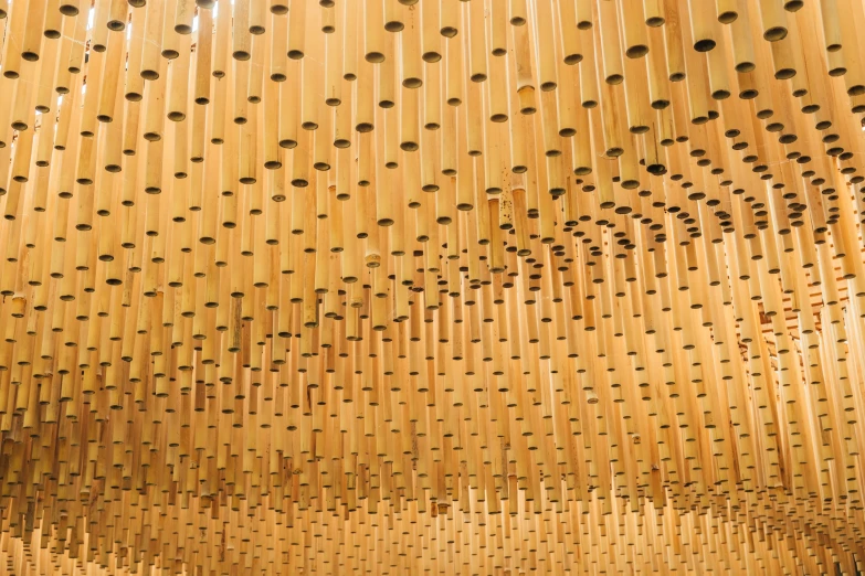 rows of round holes are suspended by strings in this modern art