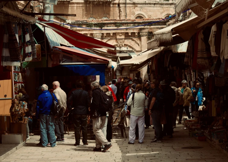 people are walking around the open air market