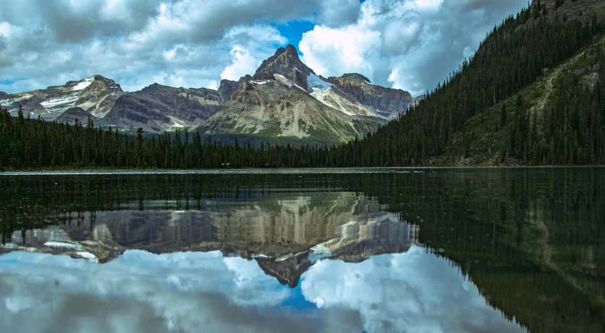 this is some mountains reflecting in a large lake