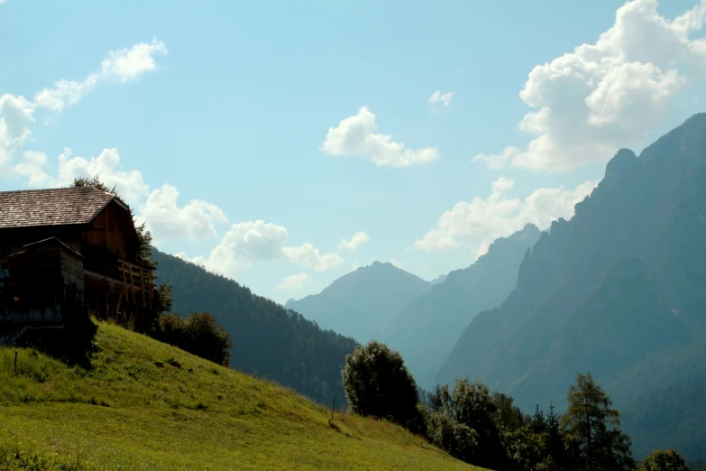 a barn is sitting on top of the mountain