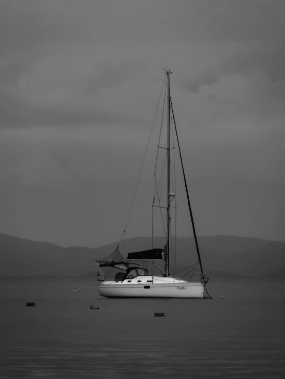a sailboat sailing on the sea with a sky background