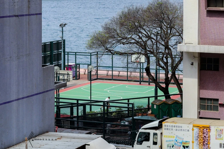 an overhead s of a basketball court, trees and buildings