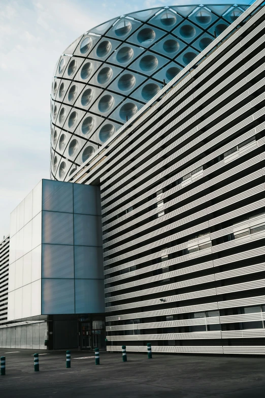 a large round building that has a long metal structure