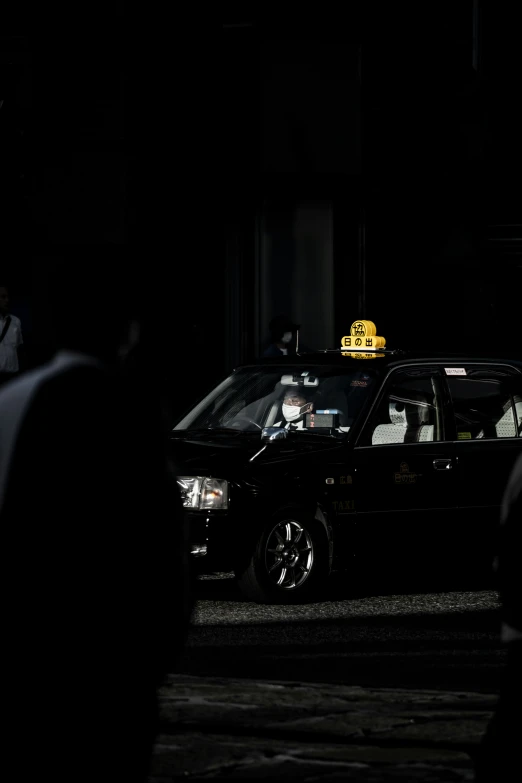 a black car with a taxi light at the top