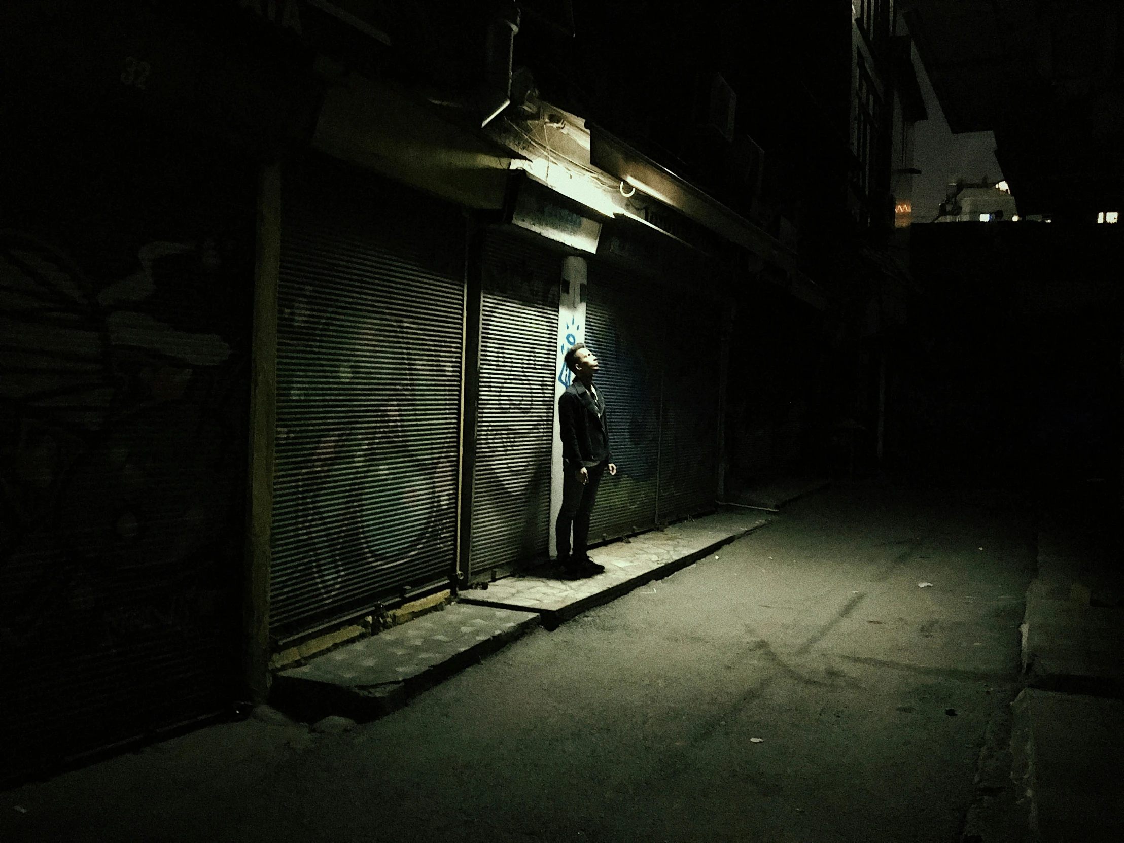 there is a man standing in the doorway of a building at night