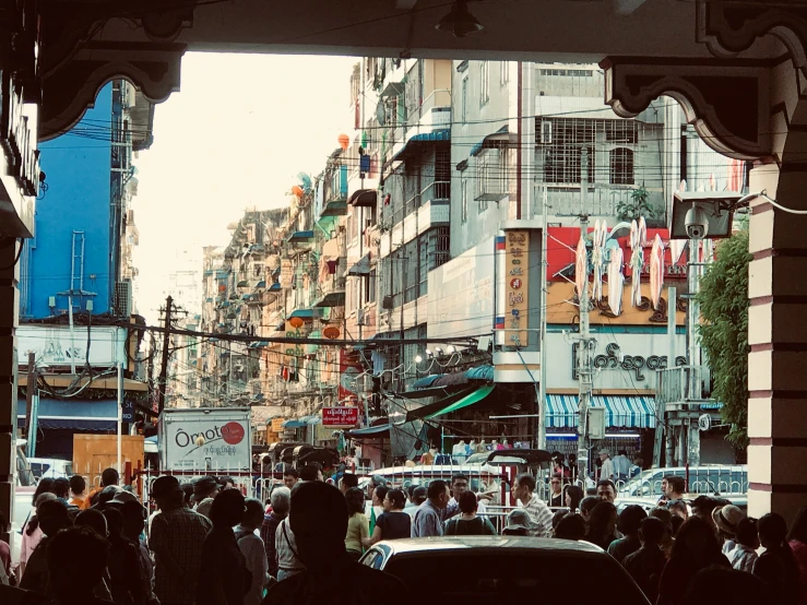 the view of a busy city street is shown through a doorway