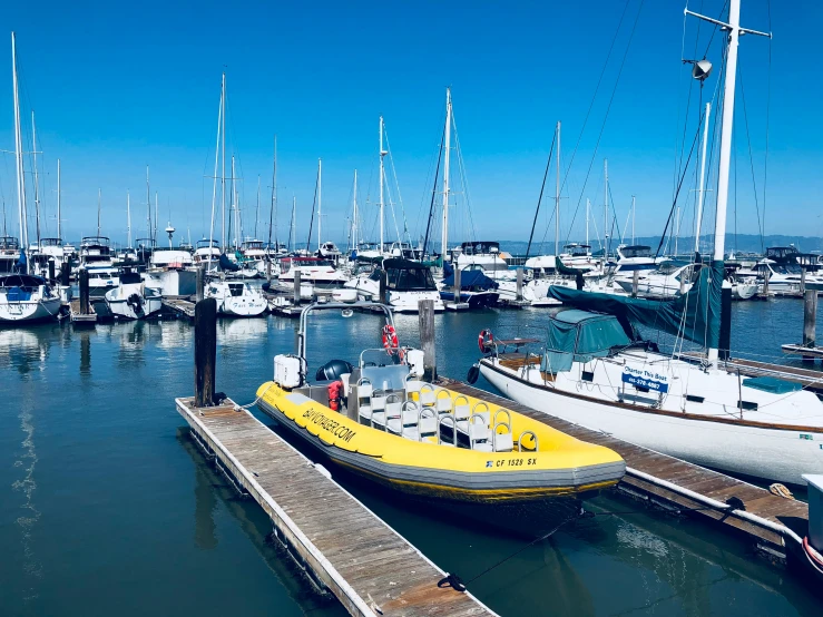 a yellow boat is docked at the harbor