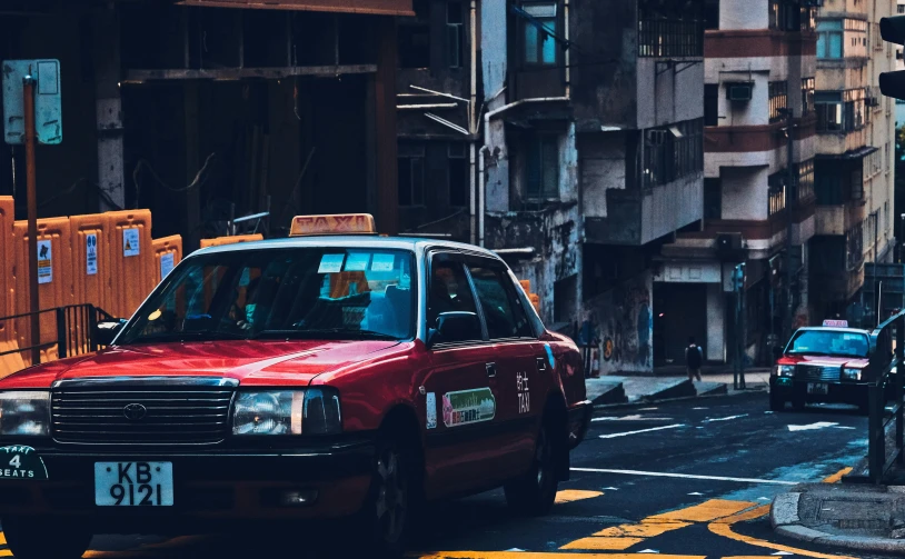 a car is parked at an intersection on a busy street