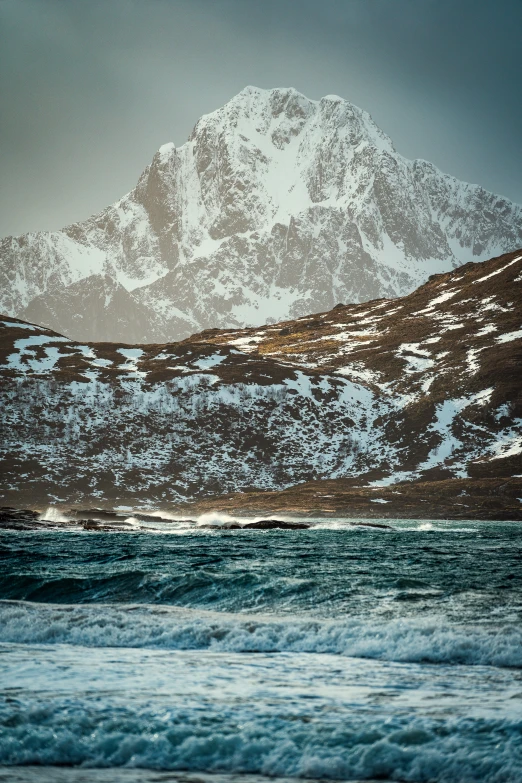 a large mountain range sitting over an ocean