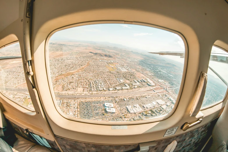 the view from inside an airplane looking out onto the landscape