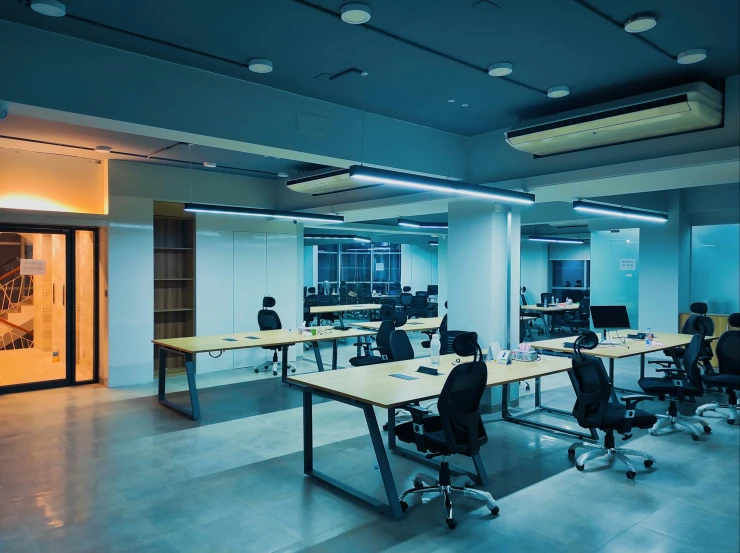 a meeting room with four people working in it