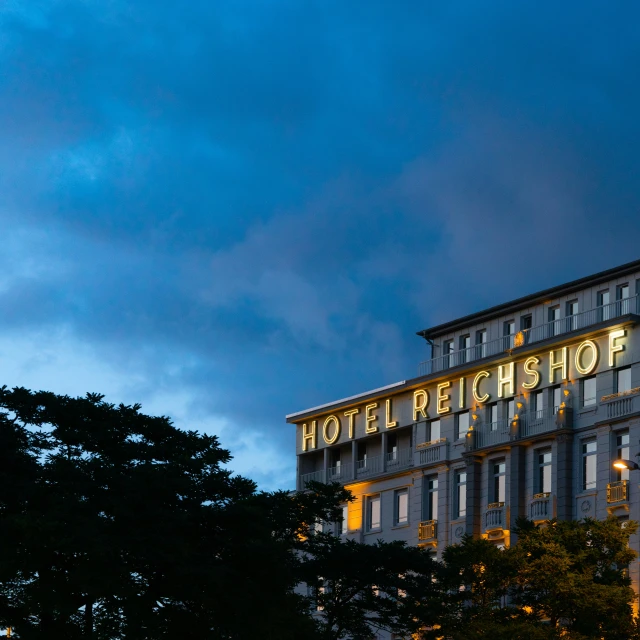 a el sign is lit up in a cloudy sky