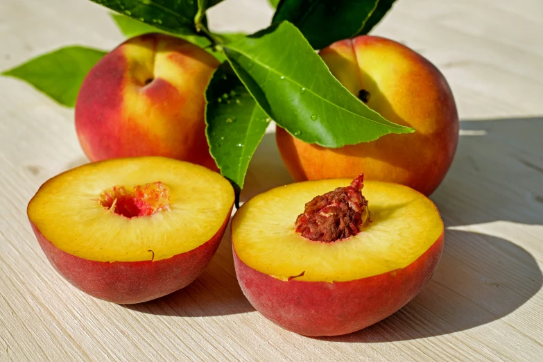 apples with one cut in half and two whole