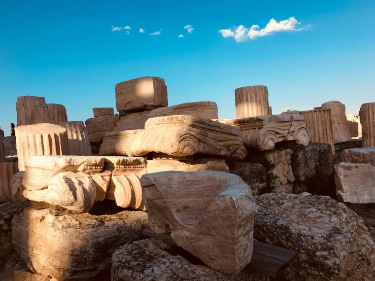 some big stone statues sitting on some rocks