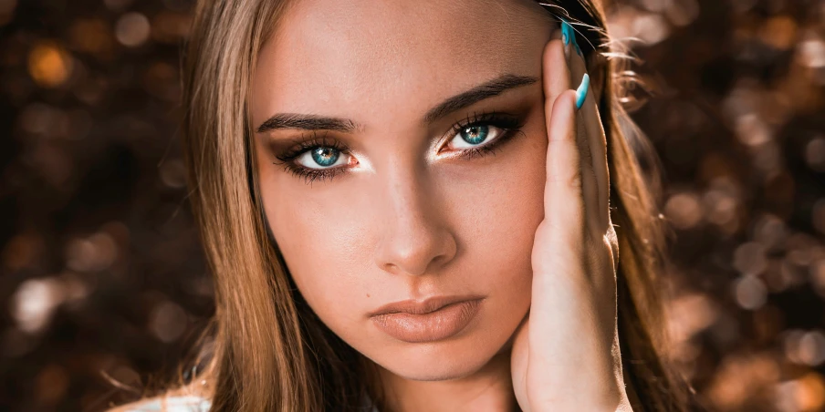 a beautiful young woman with blue eyes posing for the camera