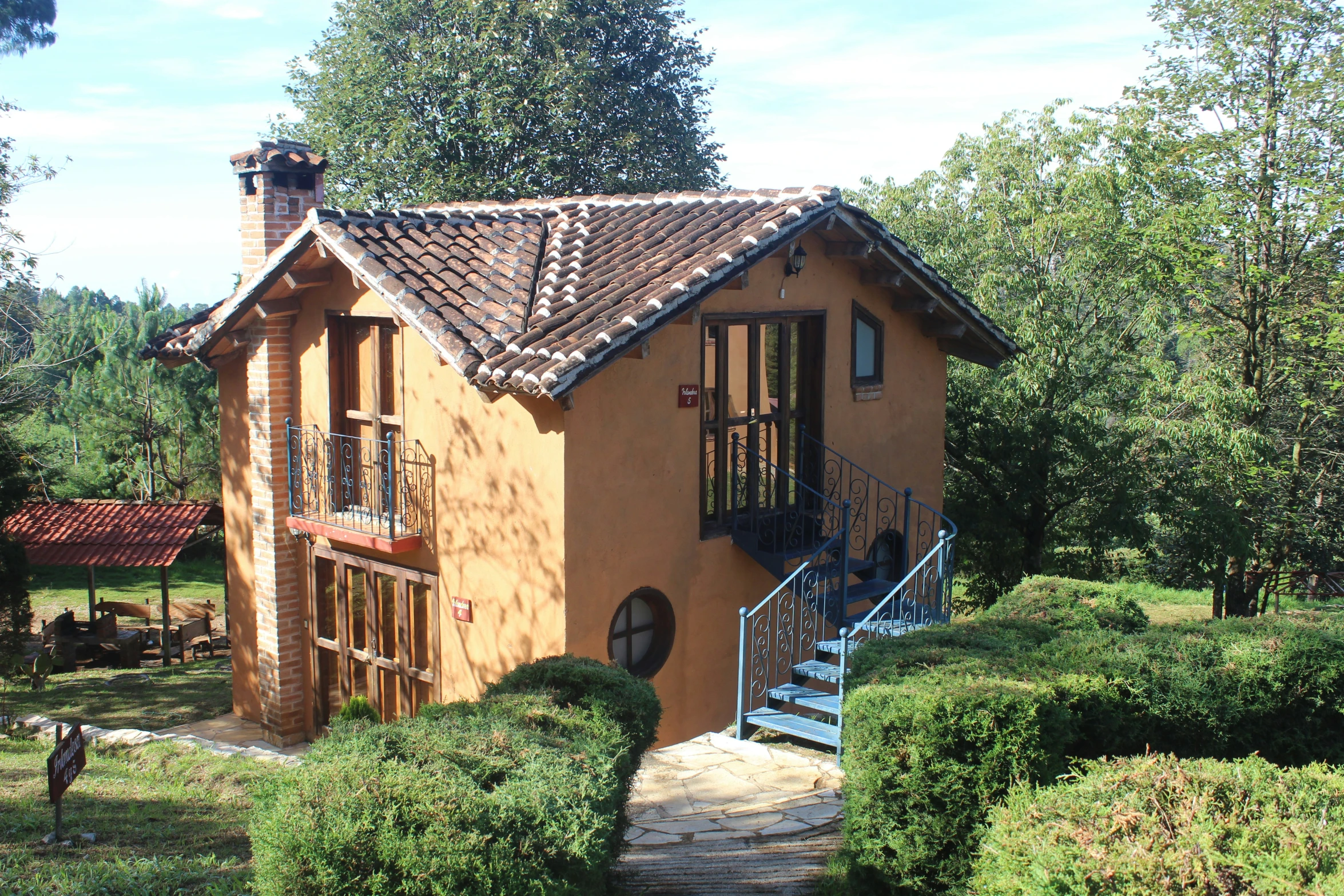 a brick home with a stone path leading up to the top