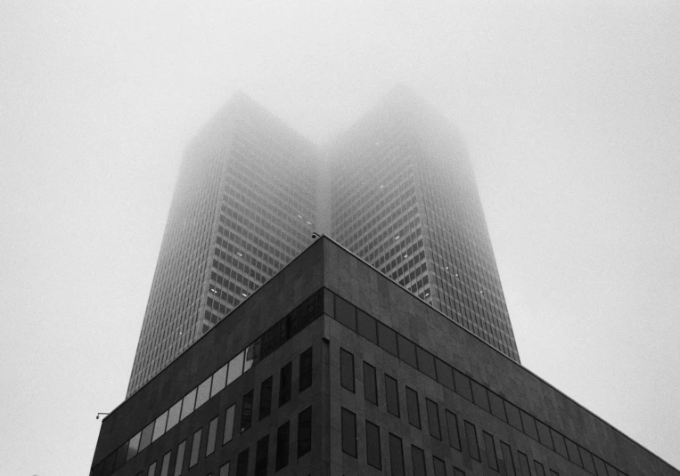 fog covers an urban building in black and white